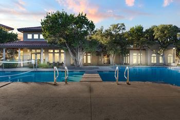 A large house with a pool in front of it.